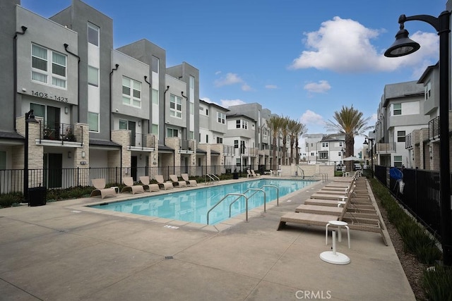 pool with a residential view and fence