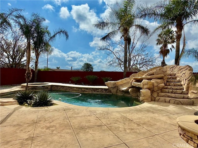 view of pool with an in ground hot tub, a patio area, a fenced backyard, and a fenced in pool