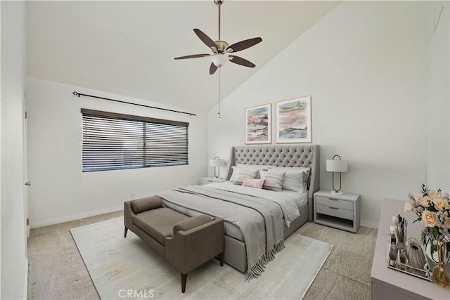 bedroom with ceiling fan, high vaulted ceiling, baseboards, and light colored carpet