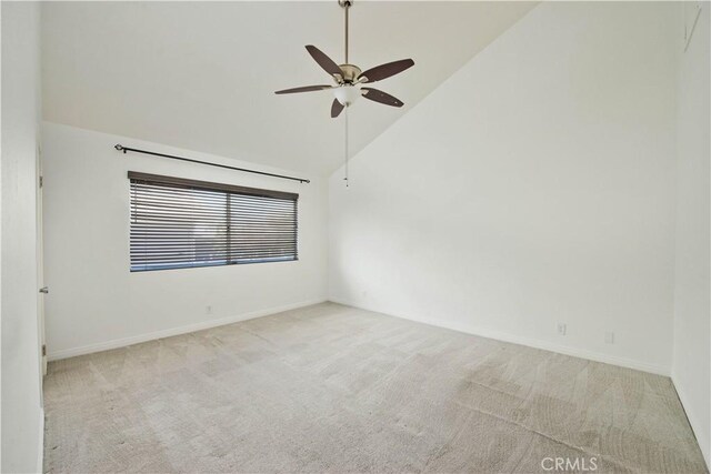 spare room featuring ceiling fan, carpet floors, high vaulted ceiling, and baseboards