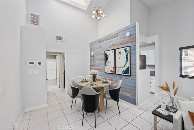 dining room with visible vents, a notable chandelier, and light tile patterned floors