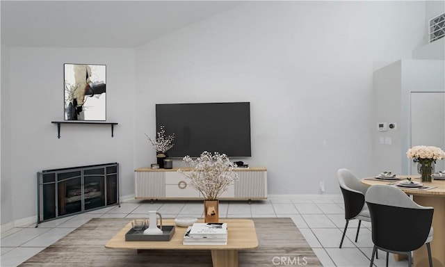 tiled living area featuring visible vents, a fireplace, and baseboards