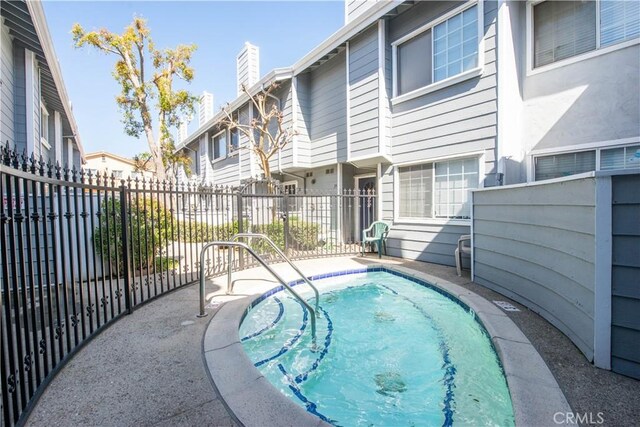 view of swimming pool with fence