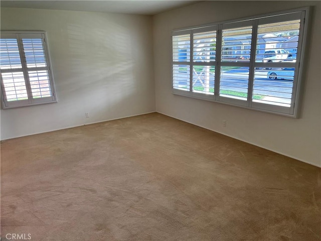 empty room with carpet floors and plenty of natural light