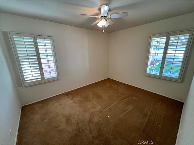 carpeted spare room with ceiling fan