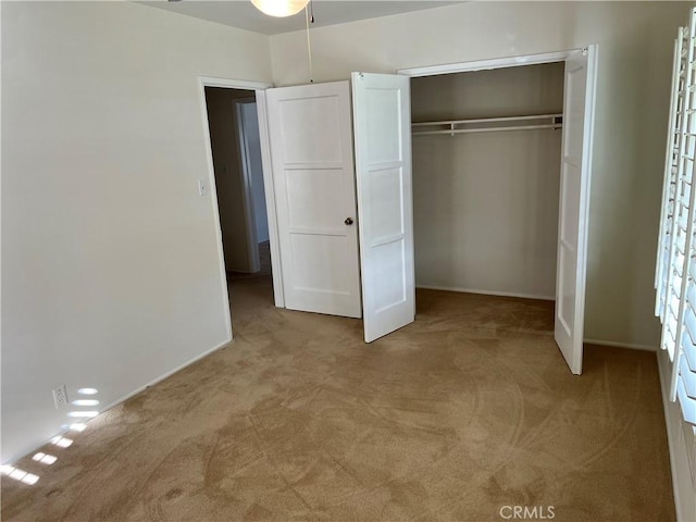 unfurnished bedroom featuring carpet floors and a closet