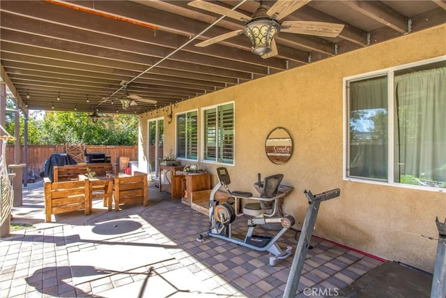 view of patio with a grill, fence, outdoor dining area, and a ceiling fan