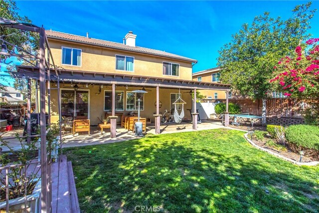 31255 Nice Ave, Mentone, CA 92359 - back of house featuring stucco siding, a chimney, and a patio