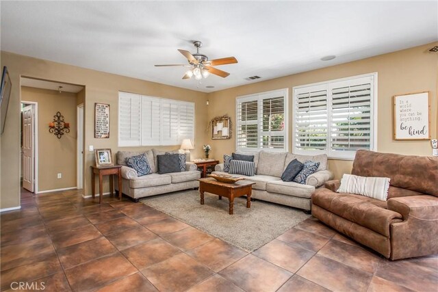 31255 Nice Ave, Mentone, CA 92359 - living room with a ceiling fan, dark tile patterned flooring, and baseboards