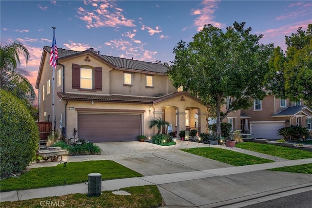 31255 Nice Ave, Mentone, CA 92359 - mediterranean / spanish-style home with a tile roof, a garage, driveway, and stucco siding