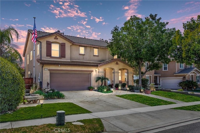 31255 Nice Ave, Mentone, CA 92359 - mediterranean / spanish house featuring a tile roof, a garage, concrete driveway, and stucco siding