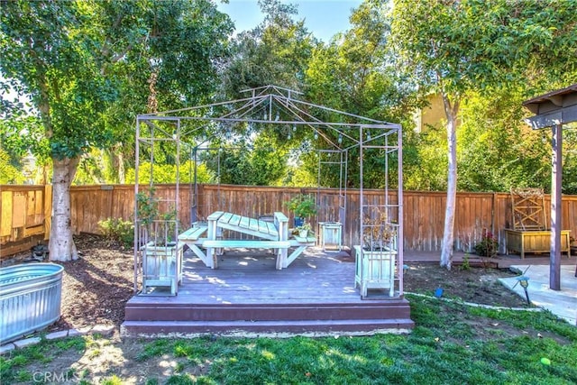 wooden deck featuring a gazebo and a fenced backyard