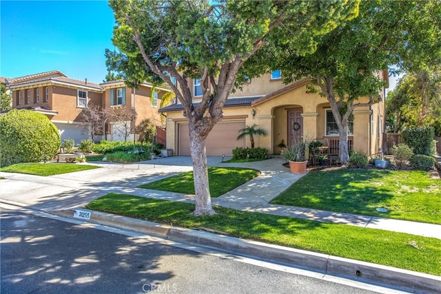 31255 Nice Ave, Mentone, CA 92359 - mediterranean / spanish home with concrete driveway, stucco siding, an attached garage, and a front yard