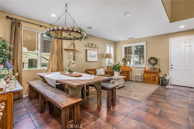 dining space featuring recessed lighting, visible vents, and dark tile patterned flooring