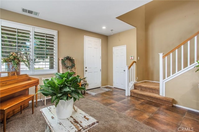 foyer entrance featuring stairway, recessed lighting, visible vents, and baseboards