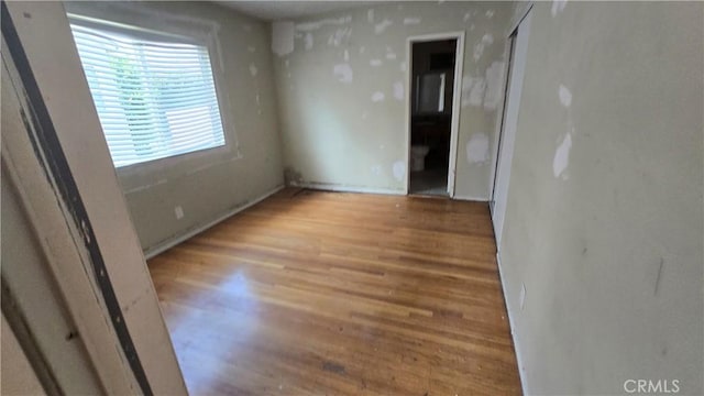 spare room featuring wood finished floors