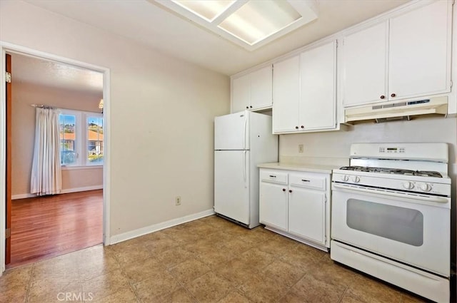 kitchen with light countertops, white appliances, white cabinets, and under cabinet range hood