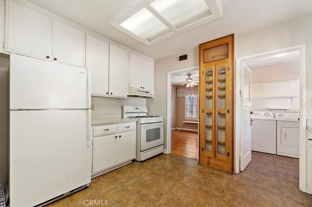 kitchen with light countertops, washing machine and dryer, white cabinets, white appliances, and under cabinet range hood