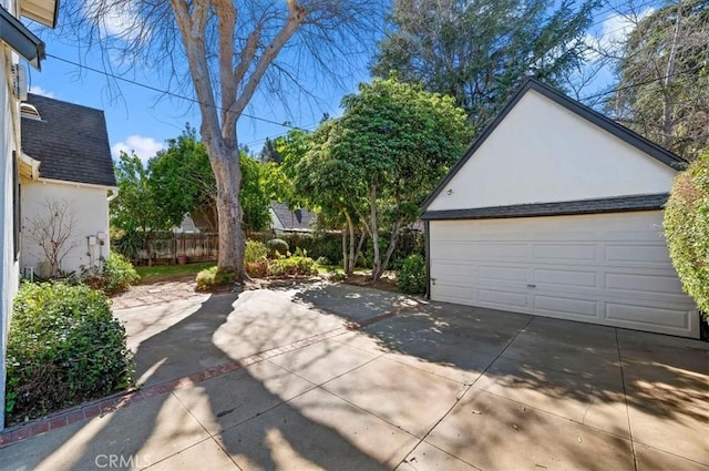 detached garage featuring fence