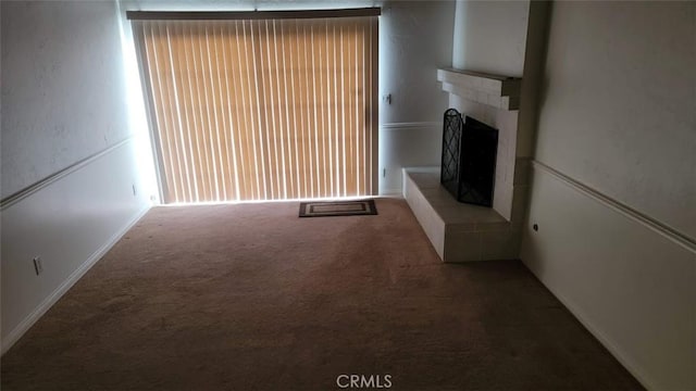 unfurnished living room featuring a fireplace and carpet flooring