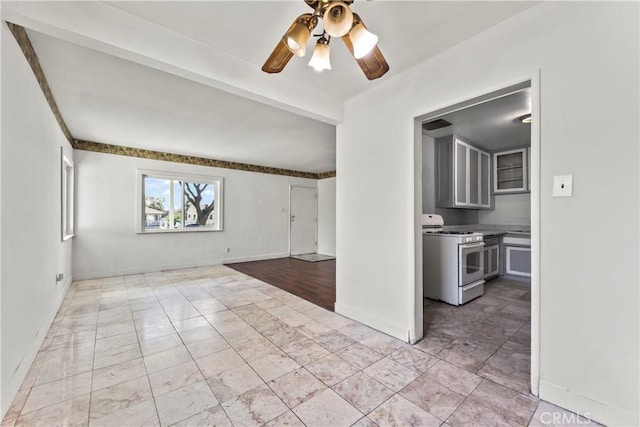 empty room with ceiling fan, beamed ceiling, and baseboards