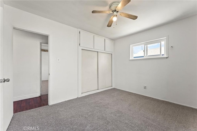 unfurnished bedroom featuring carpet floors, a closet, and a ceiling fan