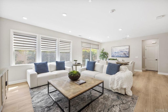 living area with recessed lighting, baseboards, and light wood finished floors