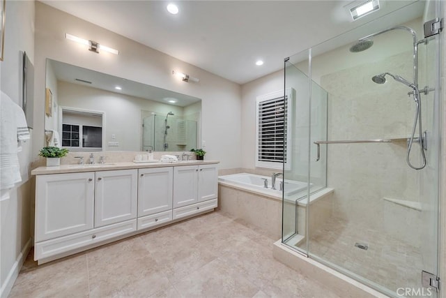 bathroom featuring double vanity, visible vents, a garden tub, a shower stall, and a sink