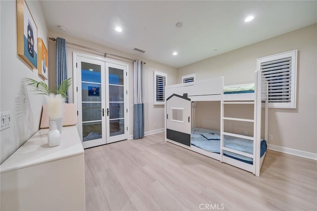 bedroom featuring recessed lighting, wood finished floors, baseboards, access to exterior, and french doors