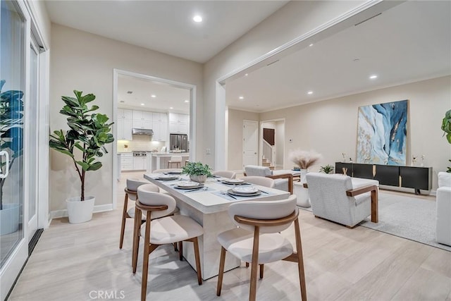 dining space featuring stairs, light wood-type flooring, baseboards, and recessed lighting