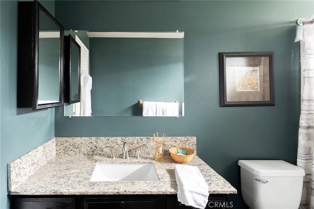 bathroom featuring toilet and vanity