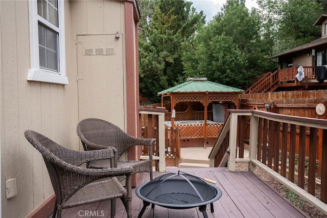 deck with a fire pit and a gazebo