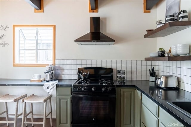 kitchen featuring gas stove, dark countertops, wall chimney exhaust hood, and open shelves