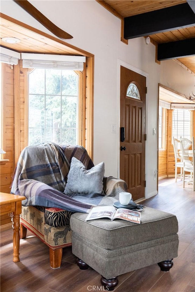 living room with beamed ceiling, wood finished floors, and wood ceiling