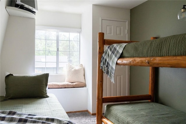 bedroom featuring carpet floors and baseboards