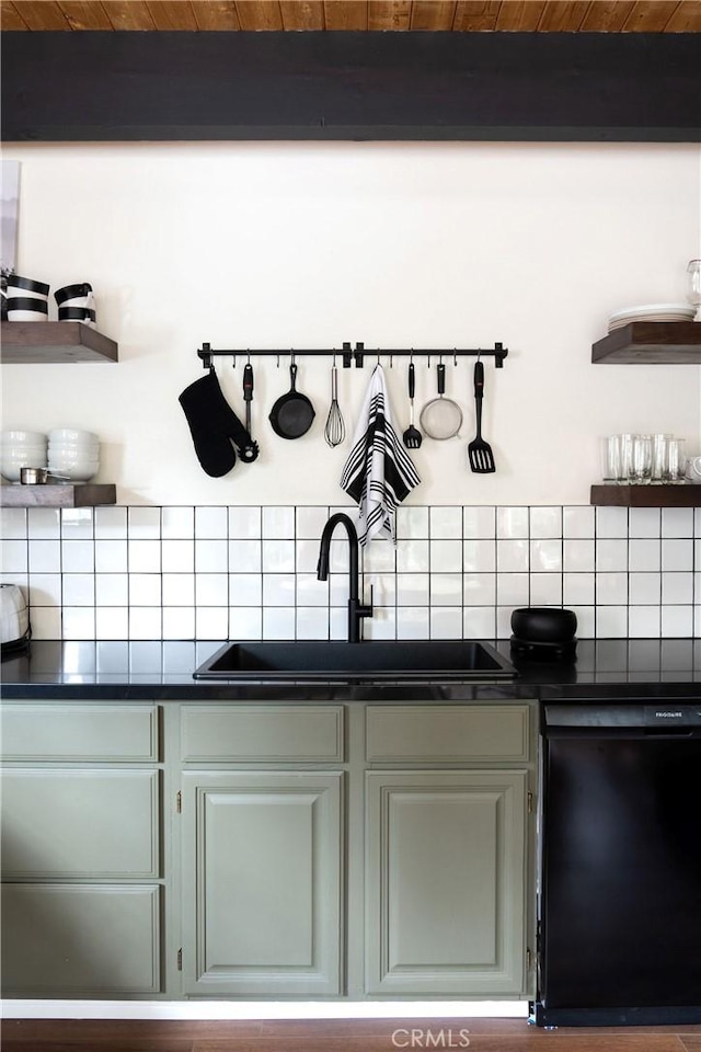 kitchen with dark countertops, black dishwasher, open shelves, and a sink