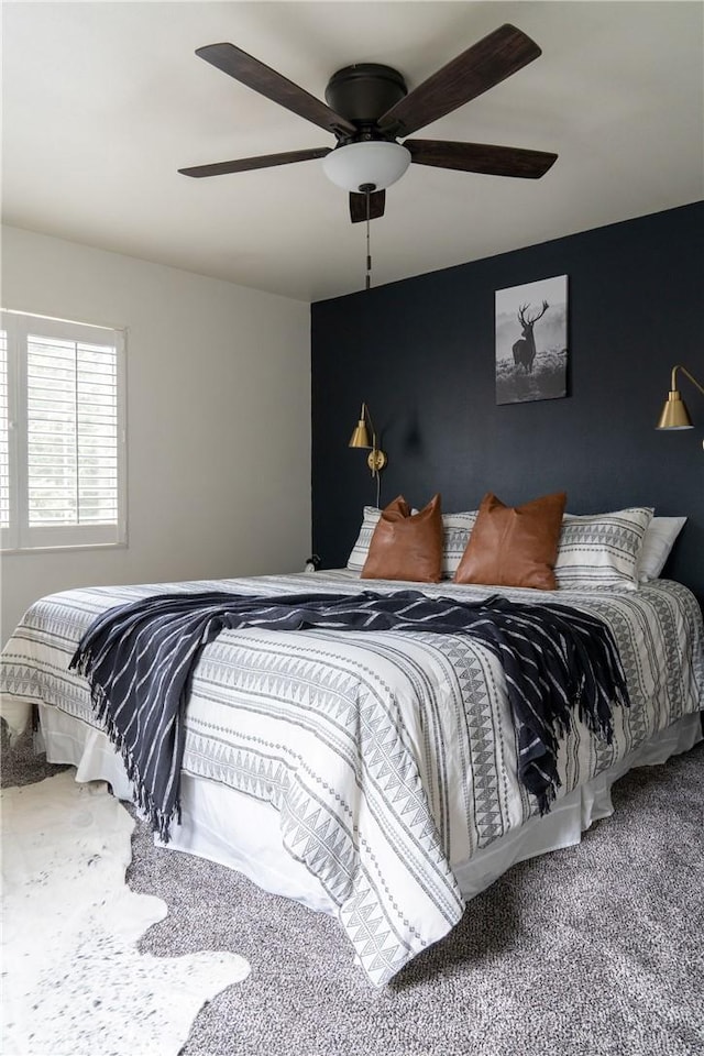 bedroom with a ceiling fan and carpet flooring