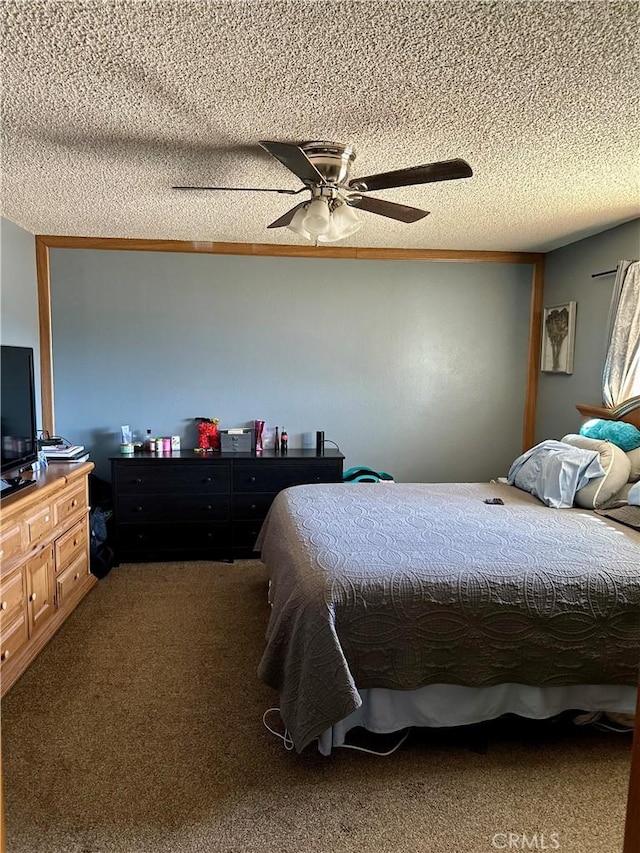 carpeted bedroom with ceiling fan and a textured ceiling