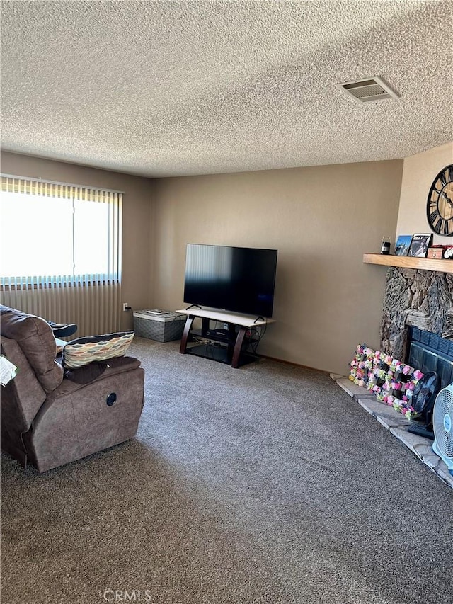 carpeted living area with visible vents, a fireplace, and a textured ceiling