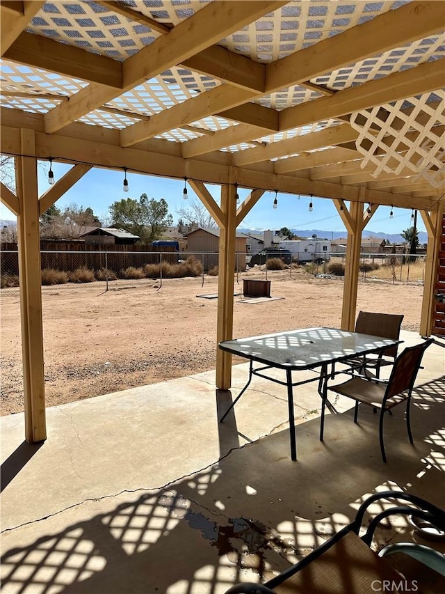 view of patio with outdoor dining area, a fenced backyard, and a pergola