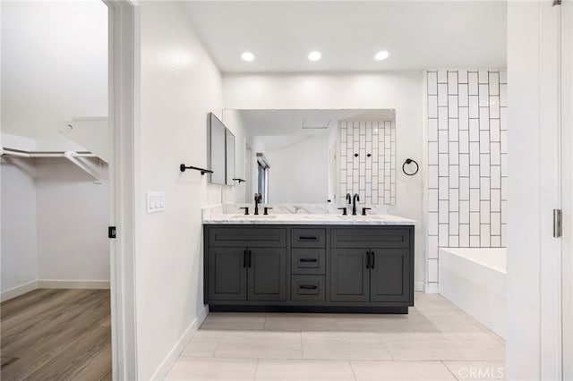 3635 Sierra Cir Unit 22, West Covina, CA 91792 - full bath featuring double vanity, a spacious closet, a bathtub, and a sink