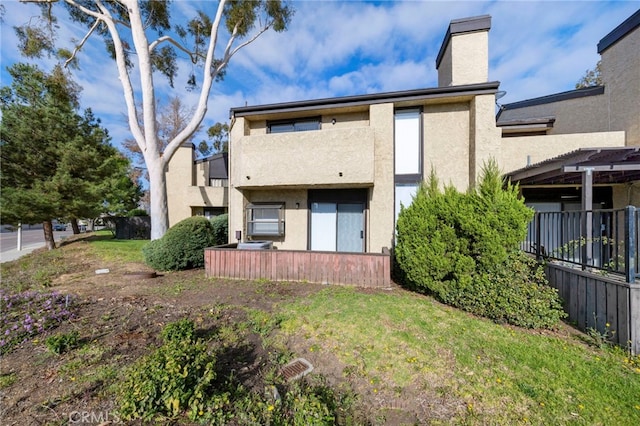 3635 Sierra Cir Unit 22, West Covina, CA 91792 - rear view of house with a chimney and stucco siding