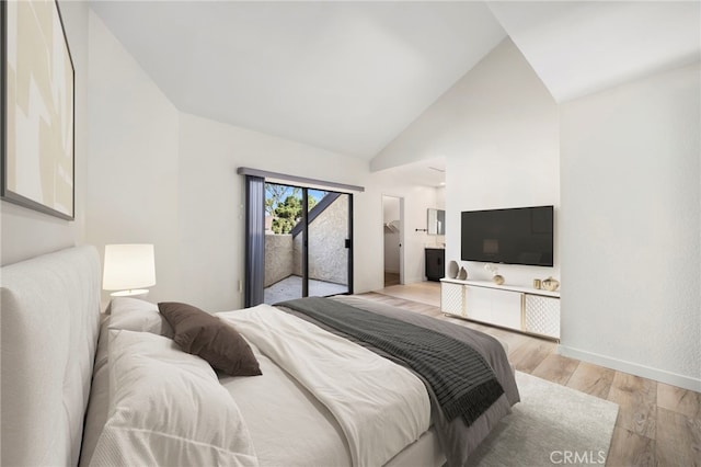 3635 Sierra Cir Unit 22, West Covina, CA 91792 - bedroom featuring access to exterior, light wood-style flooring, baseboards, and high vaulted ceiling