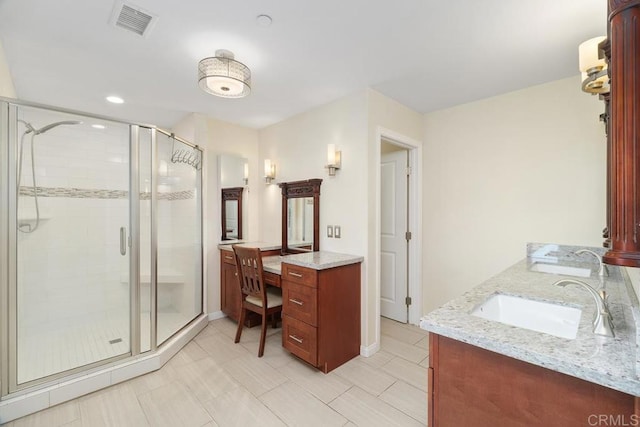 bathroom featuring double vanity, visible vents, a stall shower, and a sink