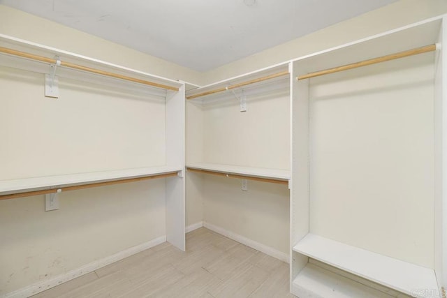 spacious closet featuring light wood-style flooring