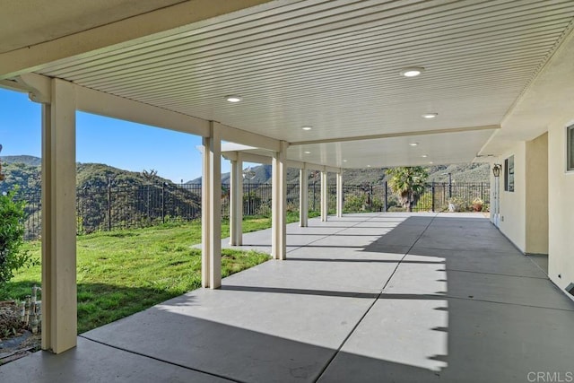 view of patio with a mountain view and a fenced backyard