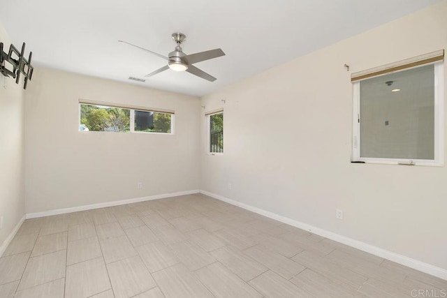 spare room with a healthy amount of sunlight and baseboards