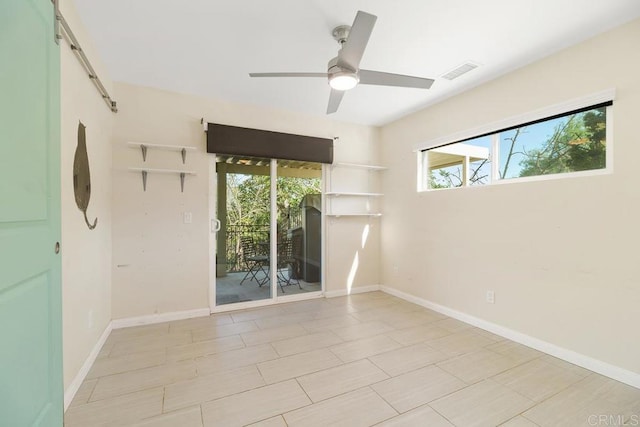 spare room with a ceiling fan, baseboards, and visible vents