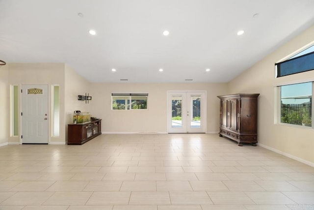 unfurnished living room with a wealth of natural light, french doors, baseboards, and recessed lighting