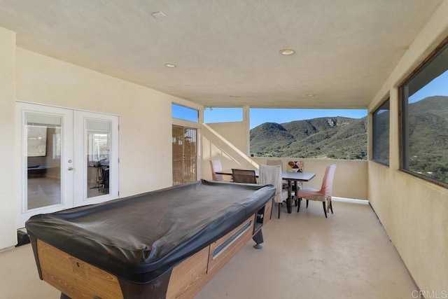 playroom with billiards, recessed lighting, french doors, concrete flooring, and a mountain view